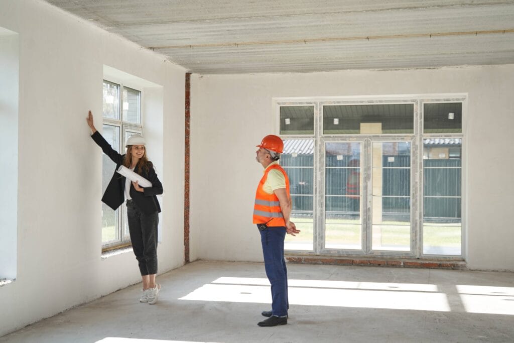 Commercial Building Inspector Explaining The Quality of The Wall